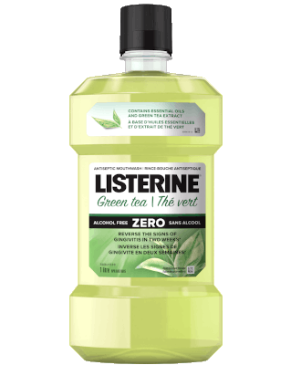 Listerine Essential Oils with Green Tea Flavour bottle against green background